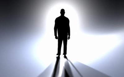 A silhouette of humanlike figure against a bright light to illustrate the article What Does the Bible Say About Angels?